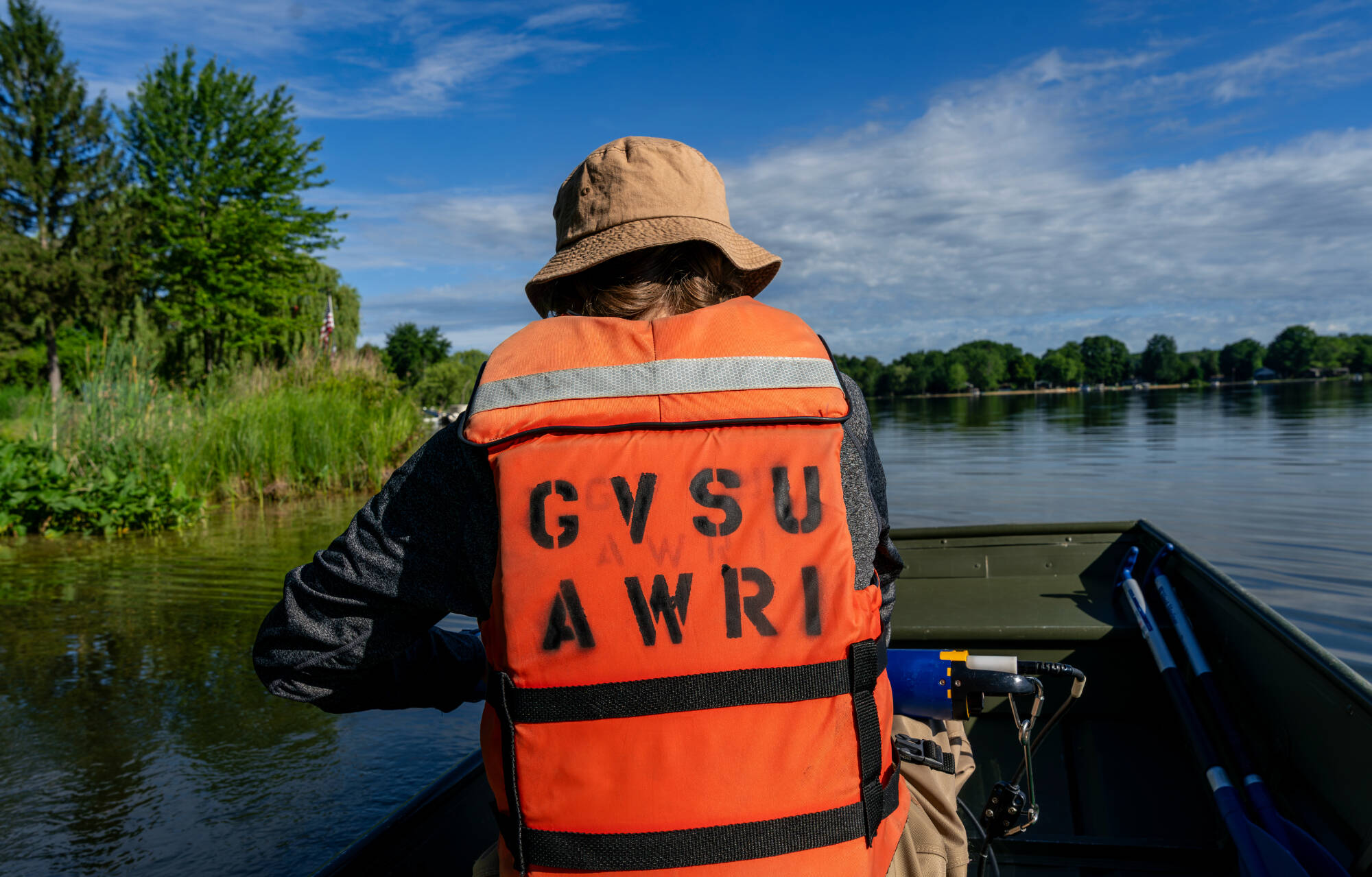 Mya Harmer, a staff member with the Steinman Lab, prepares to collect water samples at McLaren Lake in Oceana County on June 24. The sampling is part of AWRI’s inland lake salt survey. (Photo releases on file)